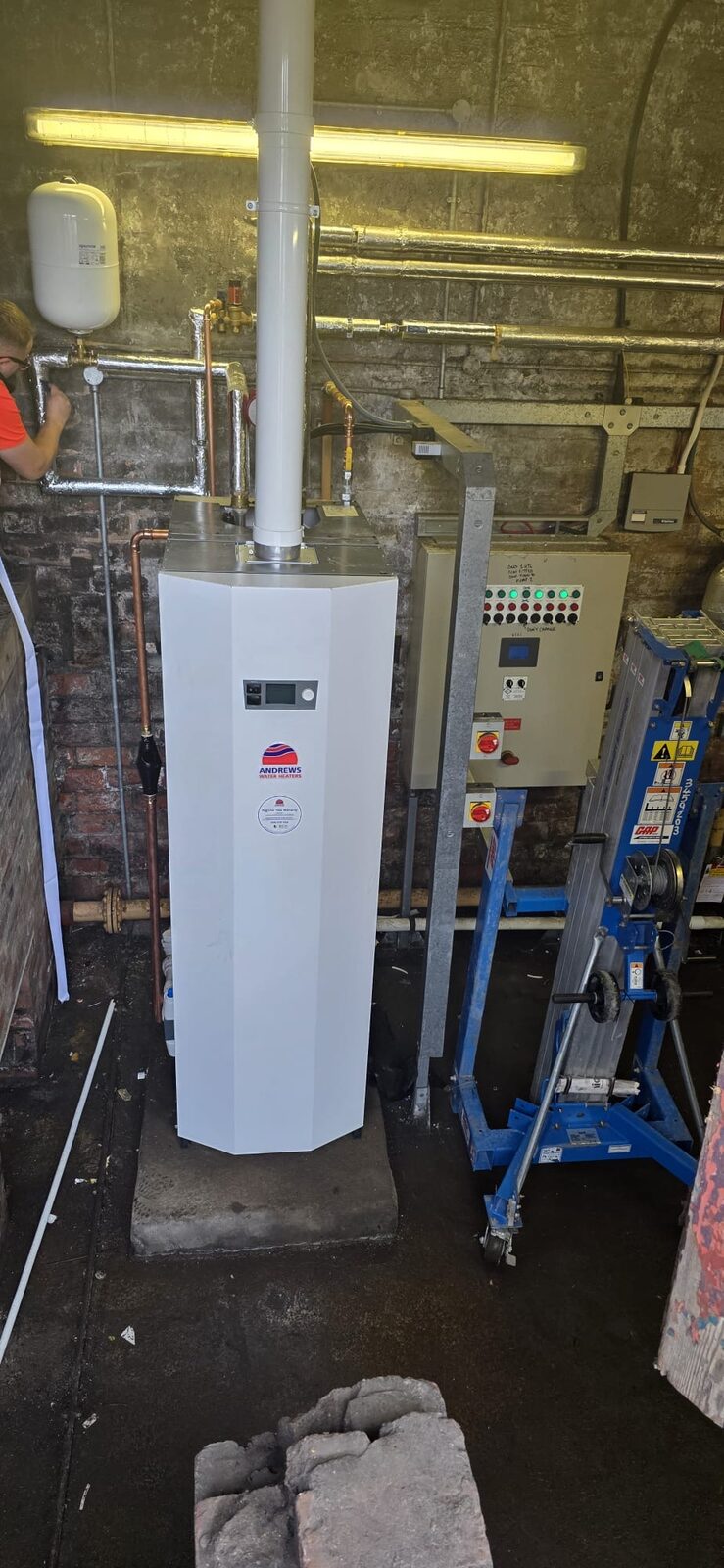 New commercial gas-fired water heater and control panel in the Craigton Primary School plant room